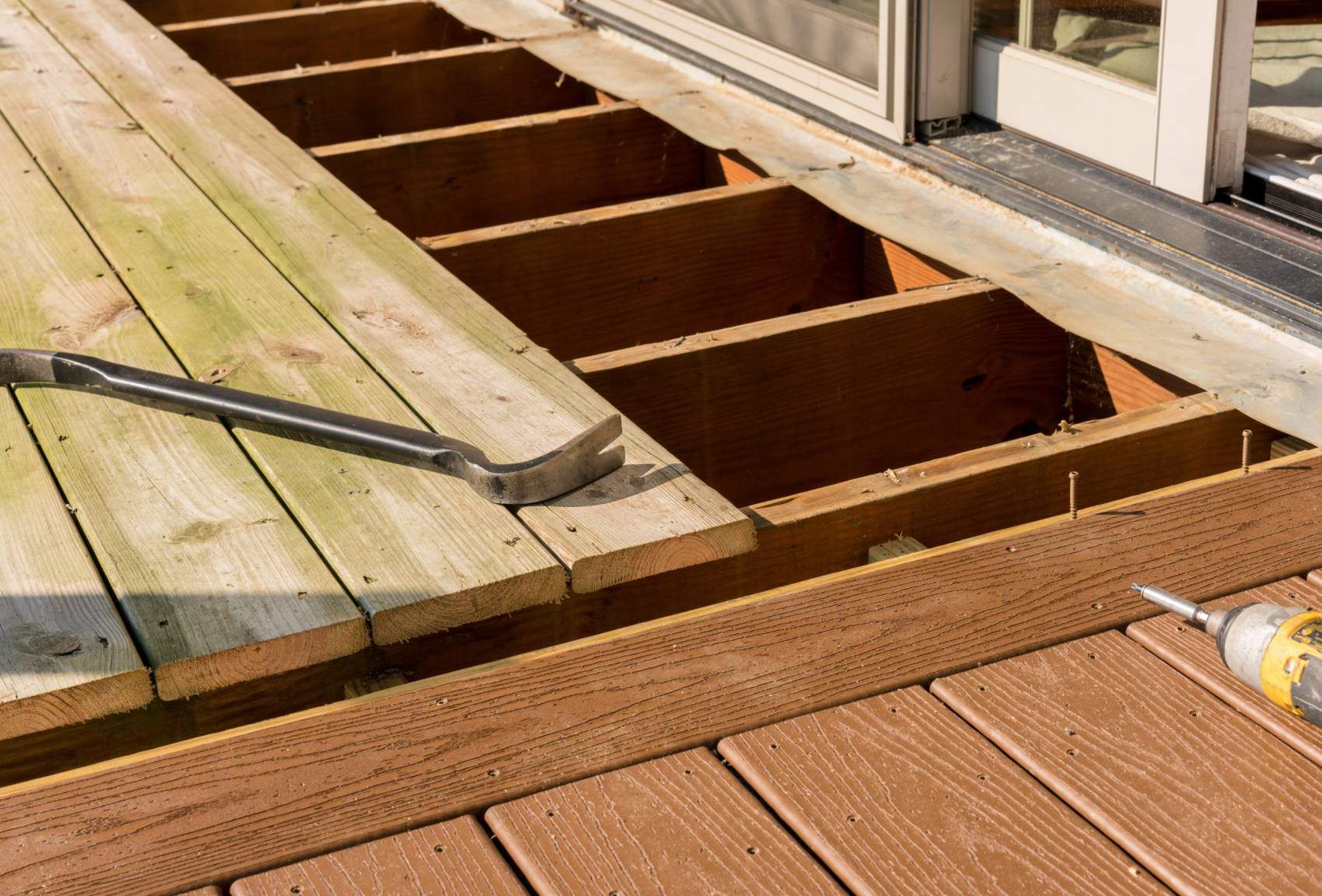 Repair and replacement of an old wooden deck or patio with modern composite plastic material