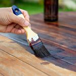 Hand painting oil color on the wooden table.