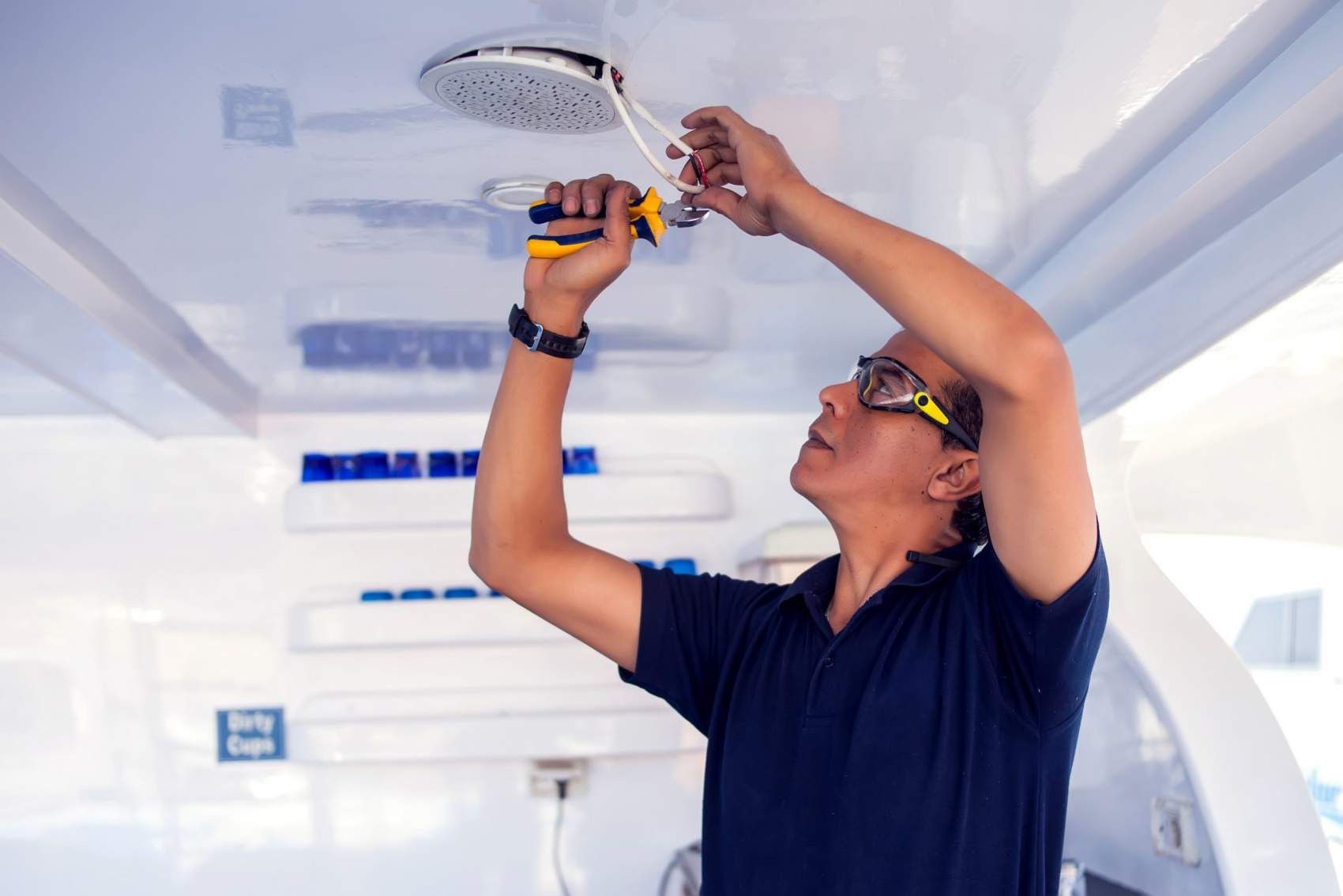 Building, renovation, technology, electricity and people concept - builder with screwdriver fixing socket