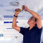 Building, renovation, technology, electricity and people concept - builder with screwdriver fixing socket